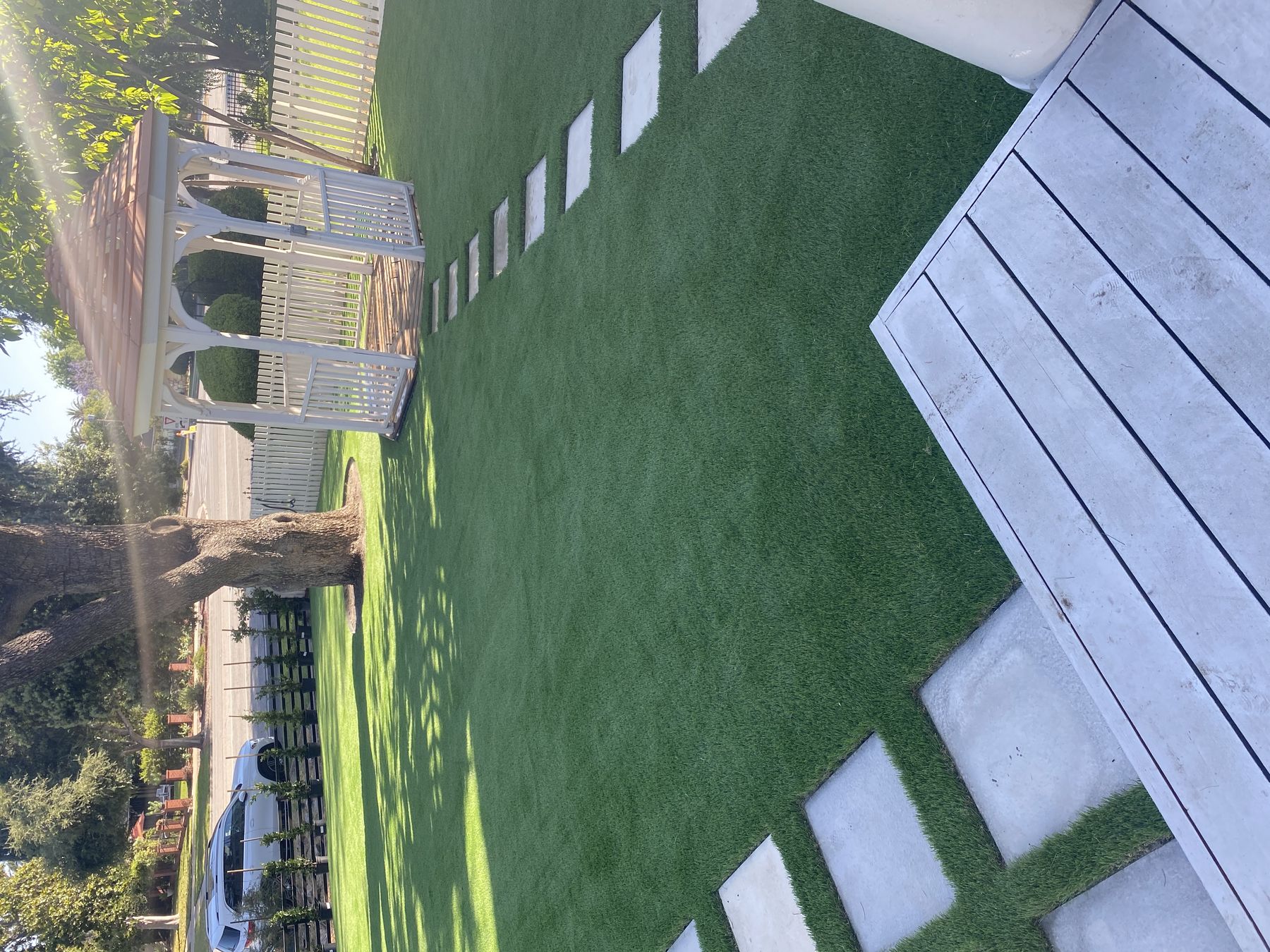 Backyard artificial turf lawn with paver stepping stones installed by 3RS Landscaping in Whittier